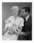 1960s happy mother and father smiling at their baby by Anonymous