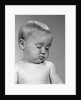1960s portrait baby nodding off to sleep by Anonymous