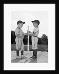 1960s two boys in baseball uniforms choosing sides by getting the upper hand on a bat by Anonymous
