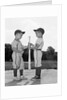 1960s two boys in baseball uniforms choosing sides by getting the upper hand on a bat by Anonymous