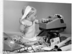 1960s baby with adding machine telephone blueprints paint samples and tape measure by Anonymous
