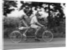 1970s teenage girl and boy riding bicycle built for two by Anonymous