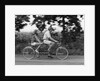 1970s teenage girl and boy riding bicycle built for two by Anonymous