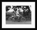 1970s teenage girl and boy riding bicycle built for two by Anonymous