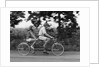 1970s teenage girl and boy riding bicycle built for two by Anonymous