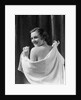 1930s smiling brunette woman looking over shoulder drying back with towel looking at camera by Anonymous
