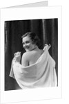 1930s smiling brunette woman looking over shoulder drying back with towel looking at camera by Anonymous