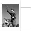 1940s 1950s smiling boy riding bike waving arm in air by Anonymous