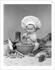 1950s 1960s baby wearing chef hat toque bowl and raw vegetables making a salad by Anonymous