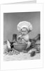 1950s 1960s baby wearing chef hat toque bowl and raw vegetables making a salad by Anonymous