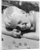 Boy crouching shooting marbles concentration by Anonymous