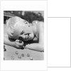 Boy crouching shooting marbles concentration by Anonymous