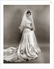 1950s full length portrait bride standing wearing satin and lace wedding gown veil and tiara looking at camera by Anonymous
