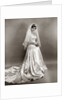 1950s full length portrait bride standing wearing satin and lace wedding gown veil and tiara looking at camera by Anonymous