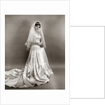 1950s full length portrait bride standing wearing satin and lace wedding gown veil and tiara looking at camera by Anonymous