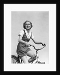 1930s smiling blonde woman riding bicycle looking at camera by Anonymous