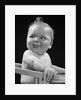 1950s 1940s baby in high chair head turned to one side with tongue sticking out funny facial expression by Anonymous