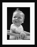 1950s 1940s baby in high chair head turned to one side with tongue sticking out funny facial expression by Anonymous