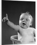 1940s 1950s baby sitting in chair arm and one finger raised objecting voting making a point looking at camera by Anonymous