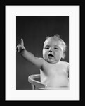 1940s 1950s baby sitting in chair arm and one finger raised objecting voting making a point looking at camera by Anonymous