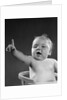 1940s 1950s baby sitting in chair arm and one finger raised objecting voting making a point looking at camera by Anonymous