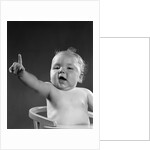 1940s 1950s baby sitting in chair arm and one finger raised objecting voting making a point looking at camera by Anonymous