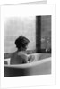 1920s 1930s woman sitting in bath tub by Anonymous