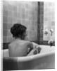 1920s 1930s young brunette woman sitting in luxury bathtub taking a bath by Anonymous