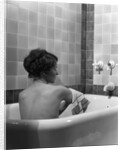 1920s 1930s young brunette woman sitting in luxury bathtub taking a bath by Anonymous