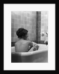 1920s 1930s young brunette woman sitting in luxury bathtub taking a bath by Anonymous