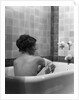 1920s 1930s young brunette woman sitting in luxury bathtub taking a bath by Anonymous