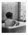 1920s 1930s young brunette woman sitting in luxury bathtub taking a bath by Anonymous