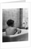 1920s 1930s young brunette woman sitting in luxury bathtub taking a bath by Anonymous