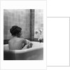 1920s 1930s young brunette woman sitting in luxury bathtub taking a bath by Anonymous
