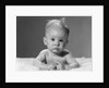 1960s portrait baby lying on stomach with messy hair and bulging eyes looking at camera by Anonymous