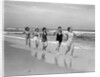 1930s four women and one man running on beach holding hands by Anonymous
