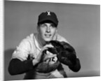 1950s baseball player with glove poised to catch ball keeping his eye on the ball by Anonymous