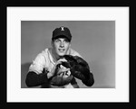 1950s baseball player with glove poised to catch ball keeping his eye on the ball by Anonymous