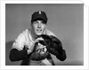 1950s baseball player with glove poised to catch ball keeping his eye on the ball by Anonymous