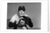 1950s baseball player with glove poised to catch ball keeping his eye on the ball by Anonymous