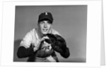 1950s baseball player with glove poised to catch ball keeping his eye on the ball by Anonymous