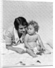 1920s 1930s woman mother lying sitting with baby on blanket by Anonymous