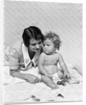 1920s 1930s woman mother lying sitting with baby on blanket by Anonymous