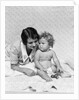 1920s 1930s woman mother lying sitting with baby on blanket by Anonymous