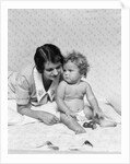 1920s 1930s woman mother lying sitting with baby on blanket by Anonymous