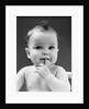 1940s thoughtful baby with finger in mouth by Anonymous