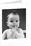 1940s thoughtful baby with finger in mouth by Anonymous