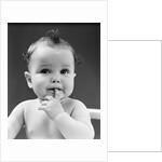 1940s thoughtful baby with finger in mouth by Anonymous