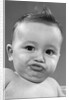 1950s baby making a funny face and bronx cheer noise looking at camera by Anonymous
