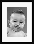 1950s baby making a funny face and bronx cheer noise looking at camera by Anonymous